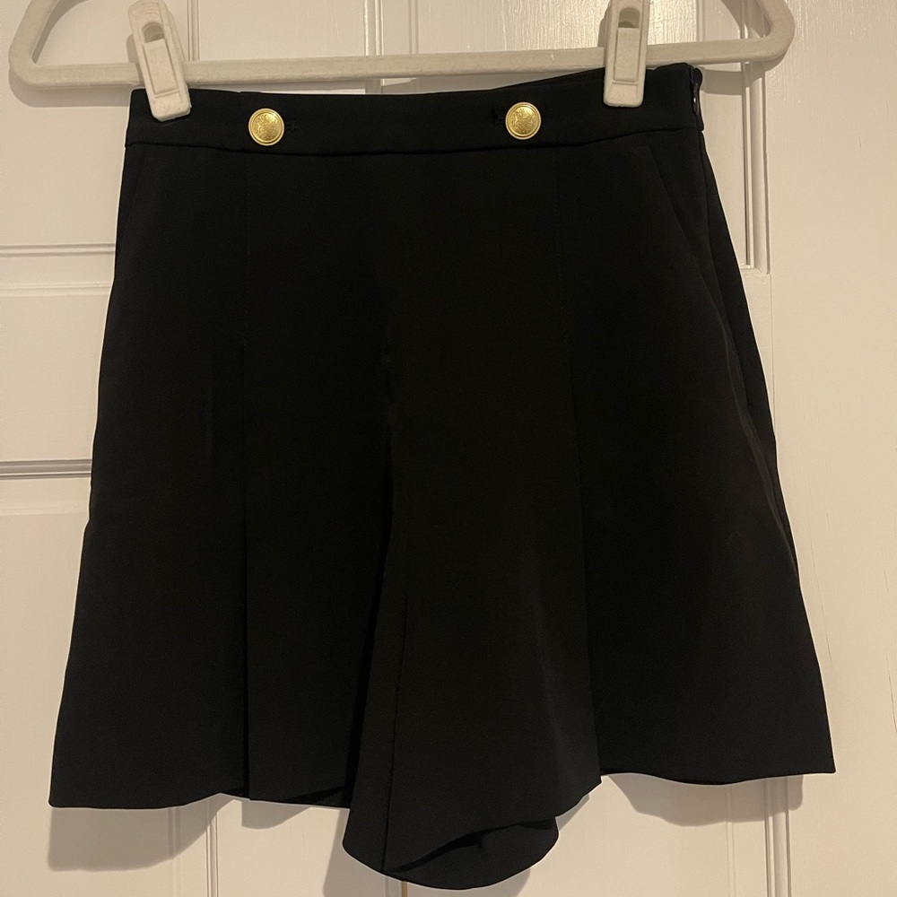 Black shorts with gold buttons